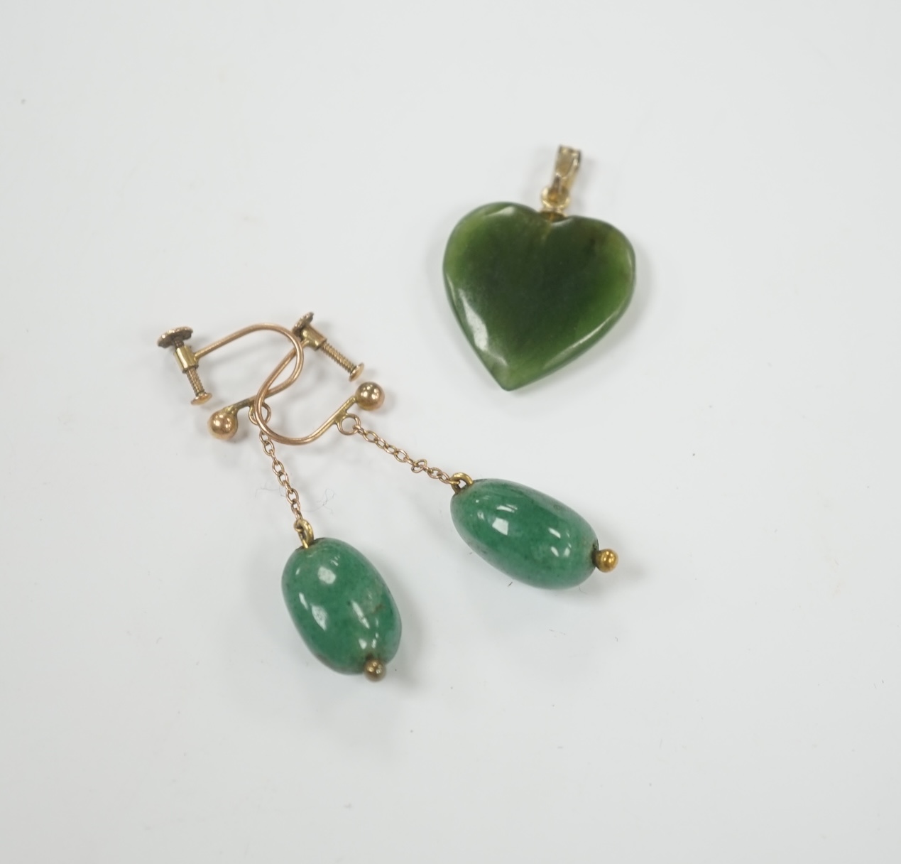 A gilt metal mounted nephrite heart shape pendant, 20mm and a pair of simulated jade earrings.